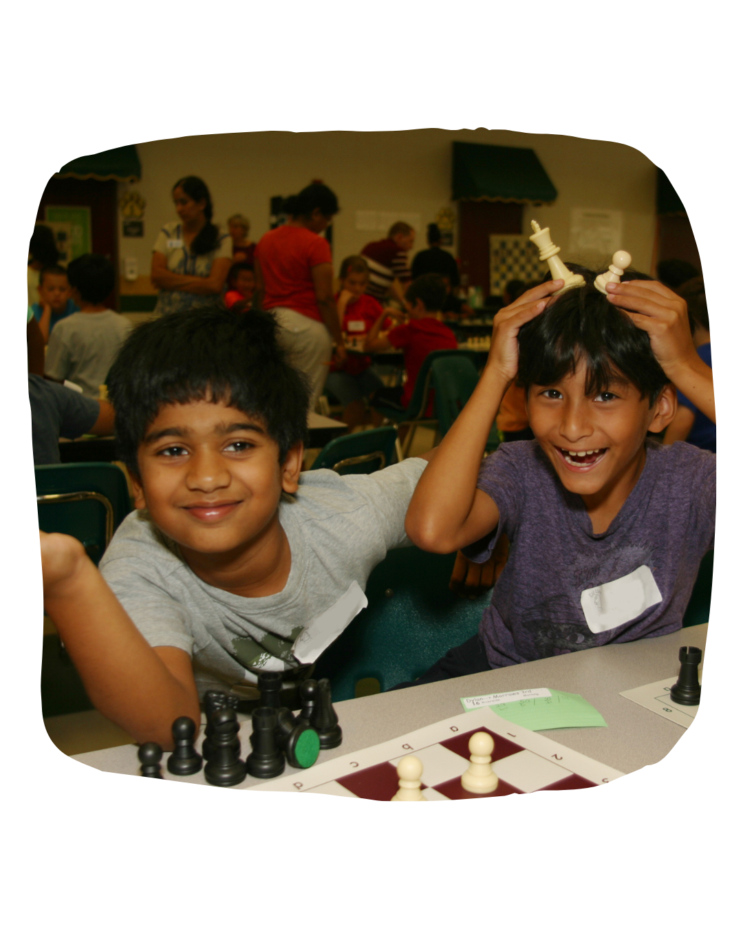 Kids playing with chess pieces and laughing