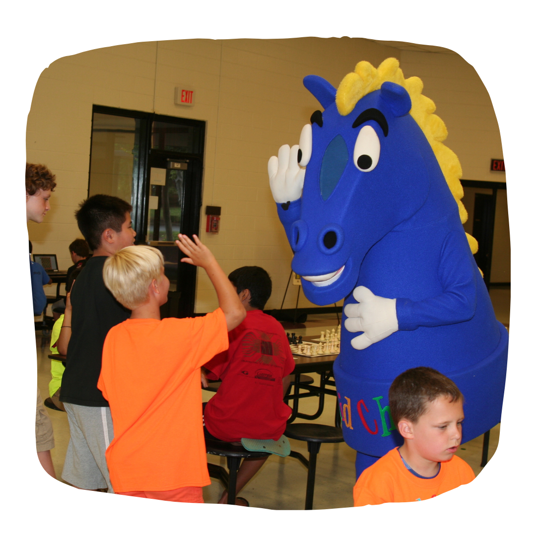 A Knight Mascot giving a high five to a camper!