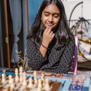 Teen girl playing chess