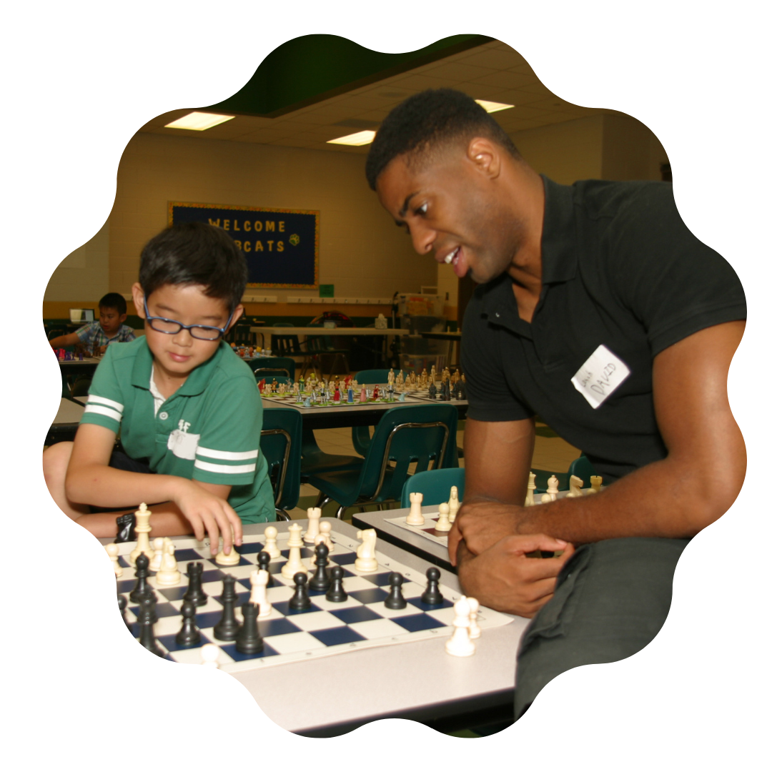 A Coach playing chess with a camper