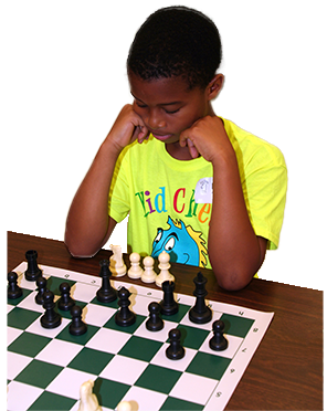 Little boy over a chess board.