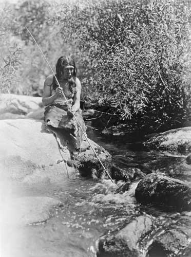 Southern Miwok man fishing with a spear by Edward S. Curtis, 1924.