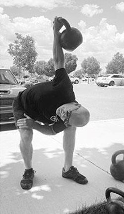 Dr. Moseley performing the kettlebell bent press