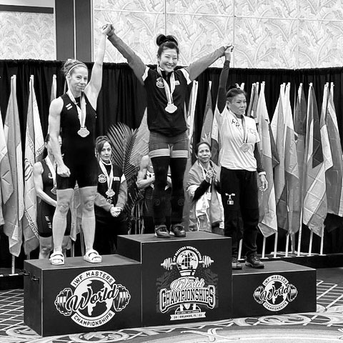 Mira Gracia on the podium of the IWF Master Weightlifting World Championships