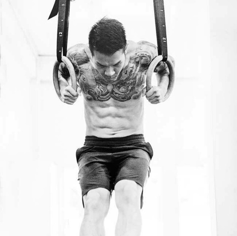 A student performing the gymnastic rings dips