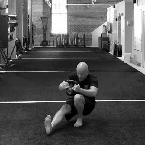 Michael Perry performing the kettlebell pistol squat