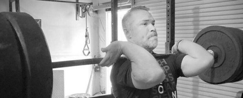 Jeremy Lay port showing the Olympic barbell front rack