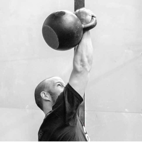 Pressing a heavy kettlebell