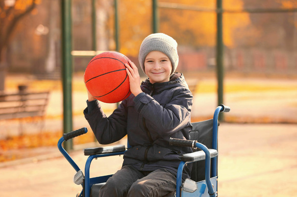 Child in wheelchair playing basketball