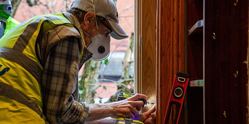 photo of a man using an impact driver