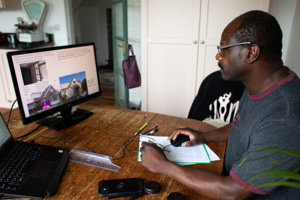 A photo of a carbon co-op member using their computer to look at their potential energy savings