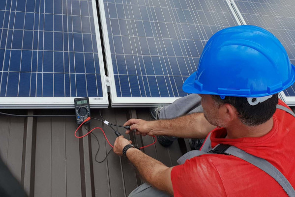 A technician installing solar panels