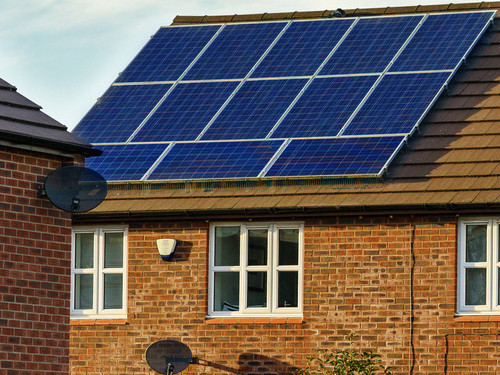 Photo of a house with solar panels on the roof
