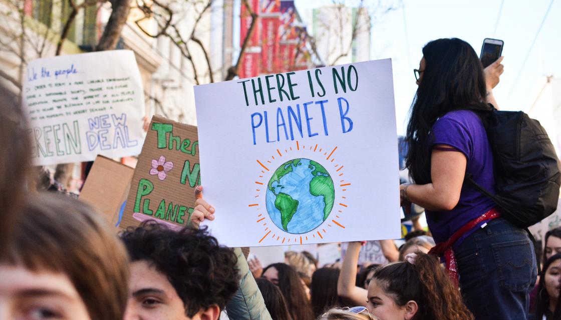 Photo from a climate demonstration with a placard saying “There is no planet B“
