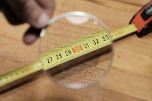 Photo of a tape measure under a magnifying glass