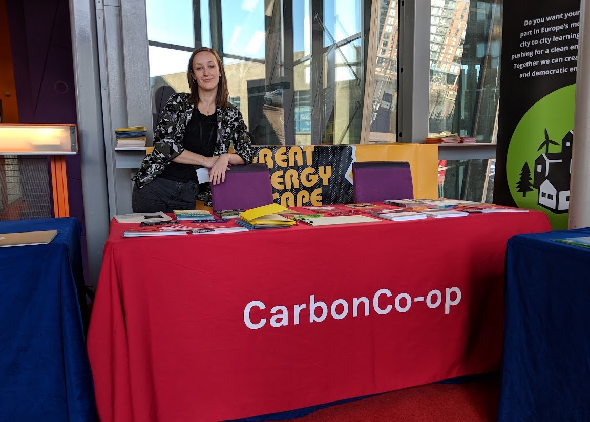A photo of a Carbon Co-op employee behind a stall