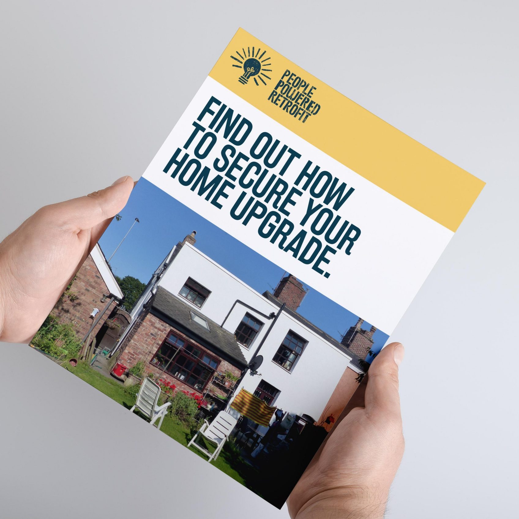 Photo of someone holding a book called 'Find Out How To Secure Your Home Upgrade'