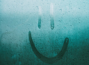 A photo of a smiley face drawn on window condensation
