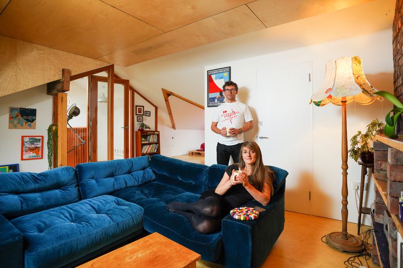 Photo of a man and a woman in the living room of their retrofitted home