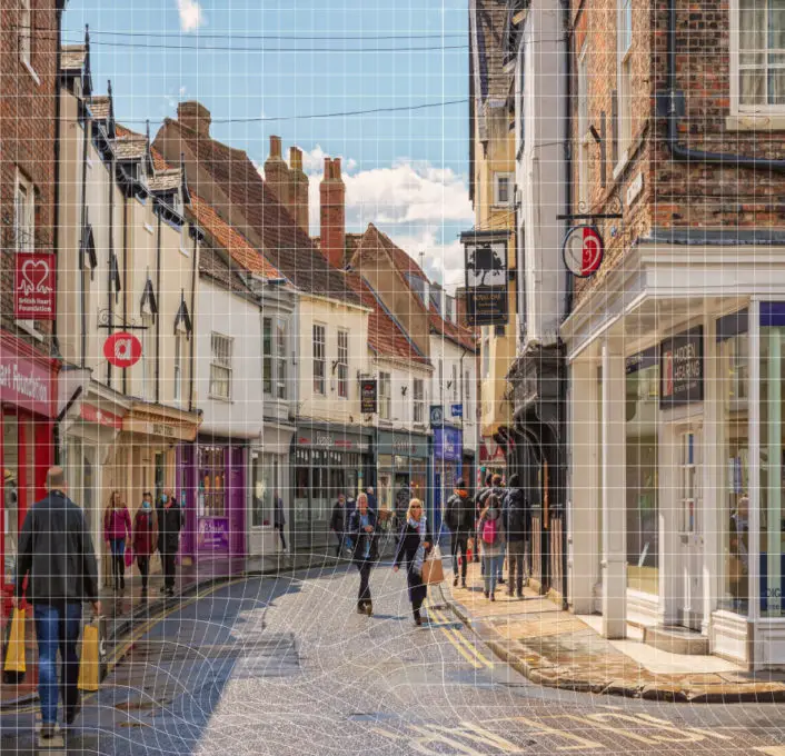 The frontcover of the report showing  a winding British High Street with a warped grid overlayed