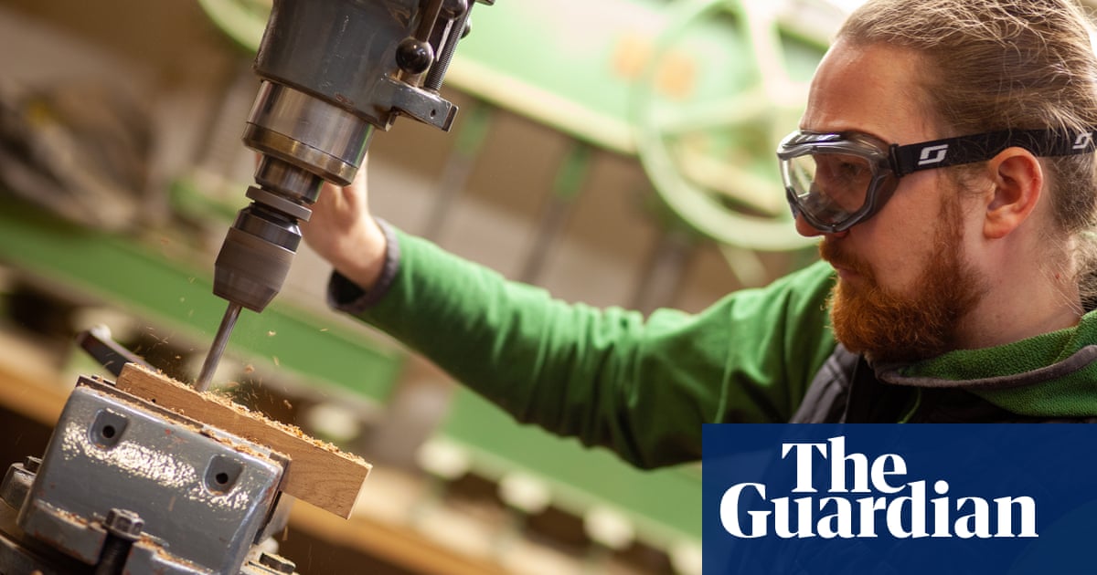 Photo of a retrofit joiner Boris Afinogenov drilling a piece of wood in his workshop
