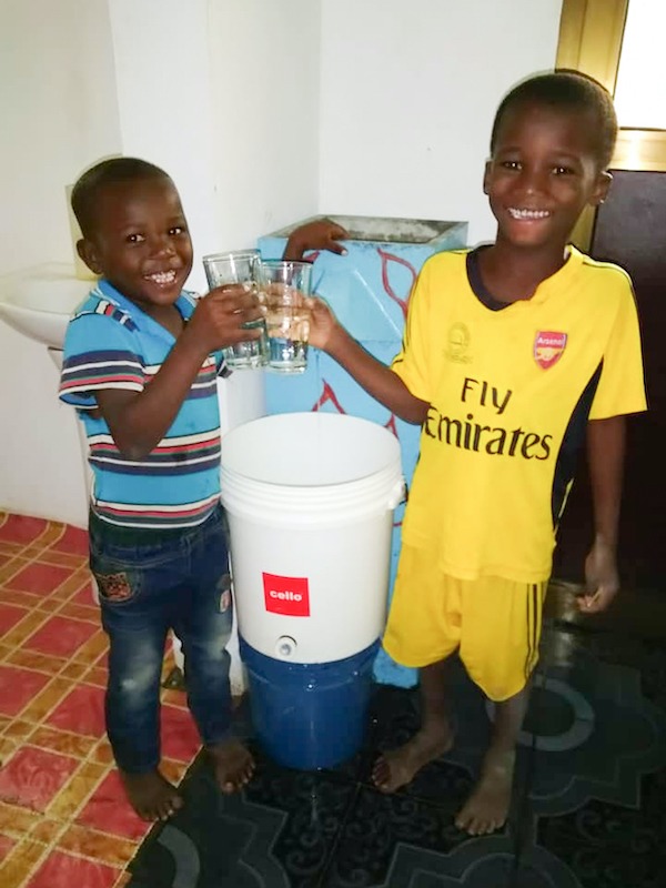 kids with a biosand water filter
