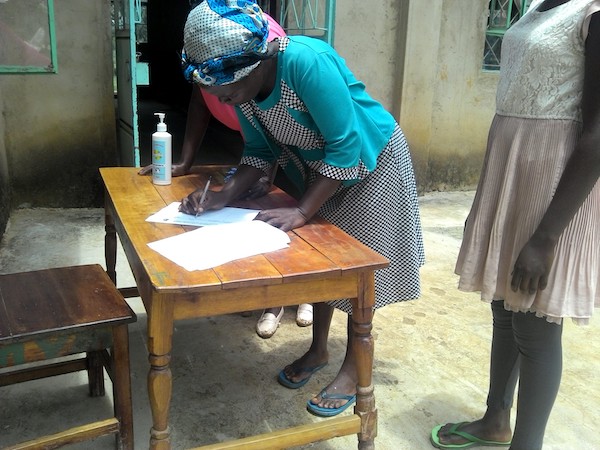 woman signing into community engagement event