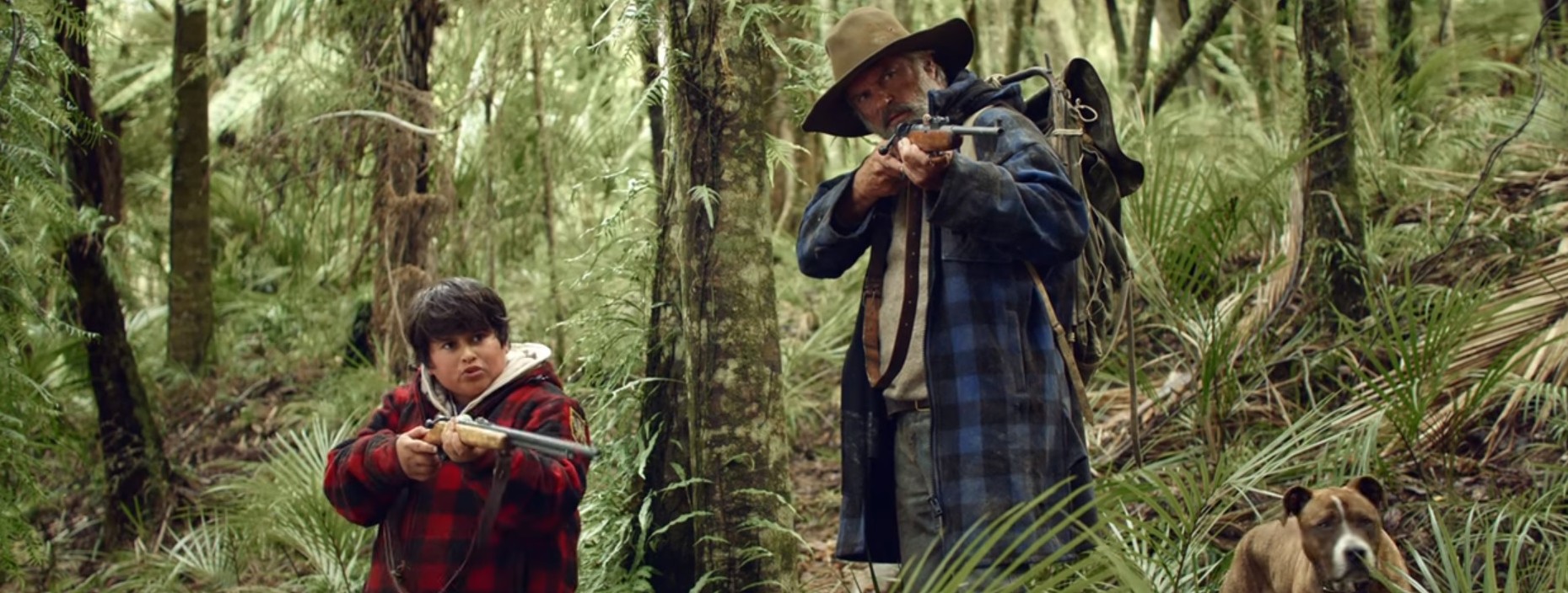 boy and old man in woods with guns