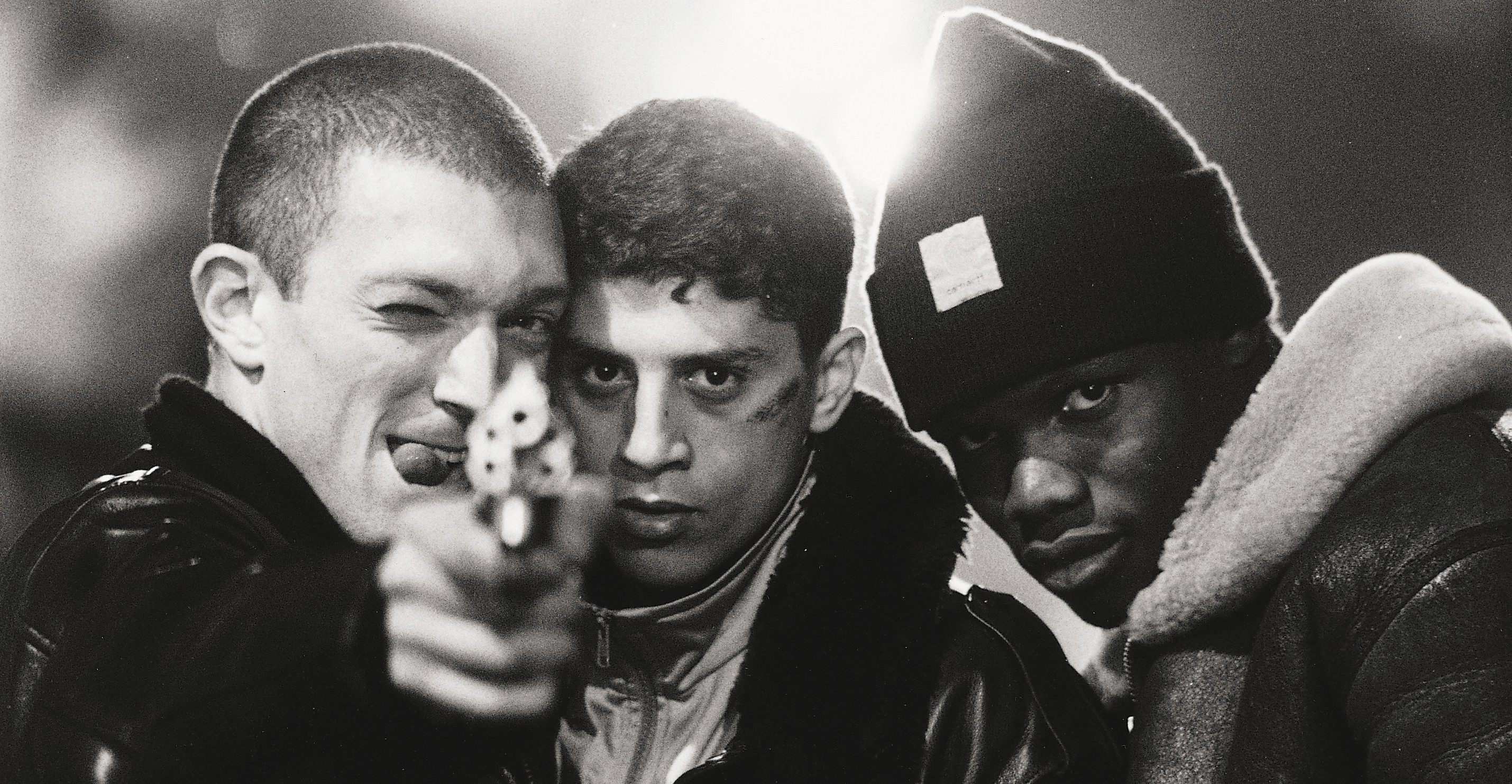 three young men with a gun