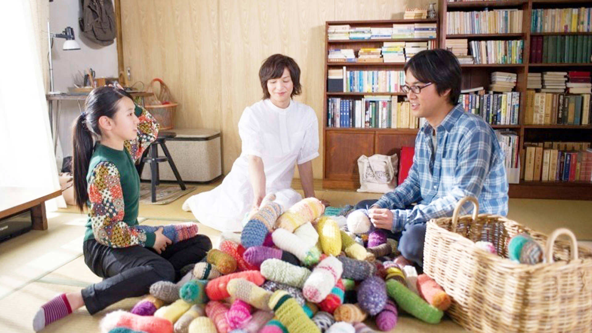 family sat around a pile of wool