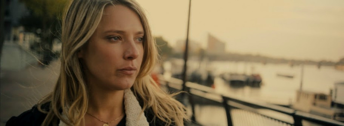 Blond woman looking out over a river