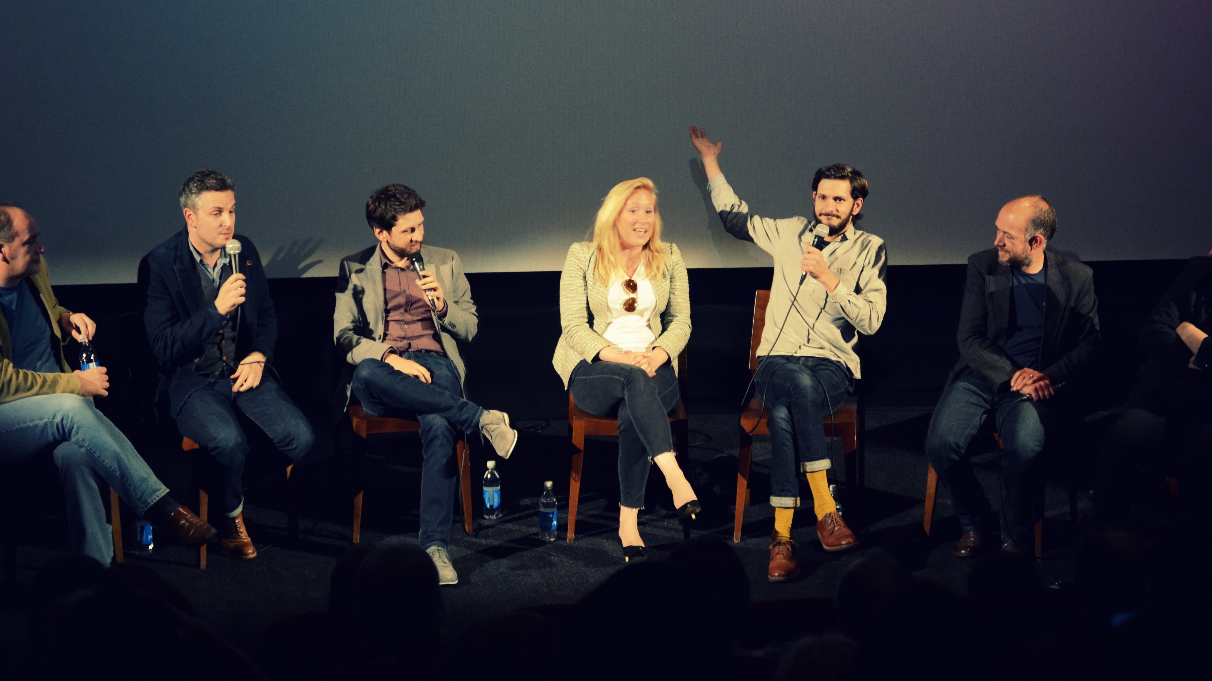 panel of guest in front of a cinema screen