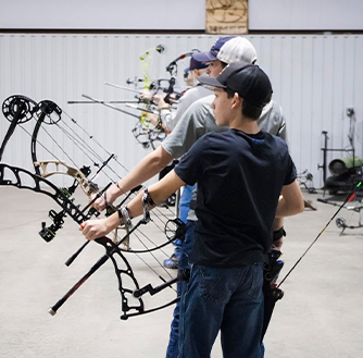 A group of teens practice archery at JNC Archery & Outdoors.