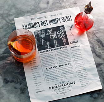 A cocktail site on a newspaper with the headline reading “Amarillo's Best Unkept Secret“.