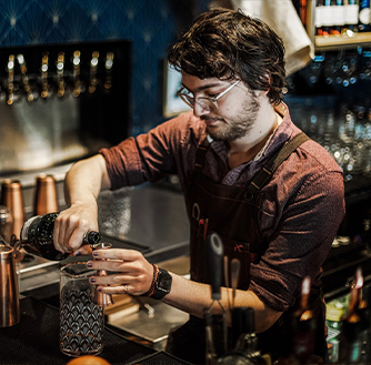 A bartender prepares a cocktail at the Royal Bar.